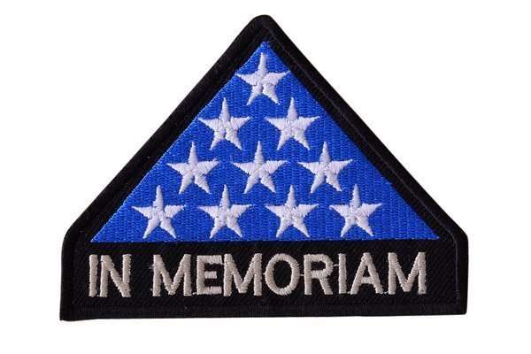 A front view of the blue and black embroidered biker patch featuring white stars and text