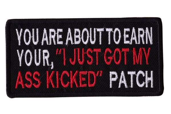 Close-up front view of a black embroidered biker patch with white and red stitching