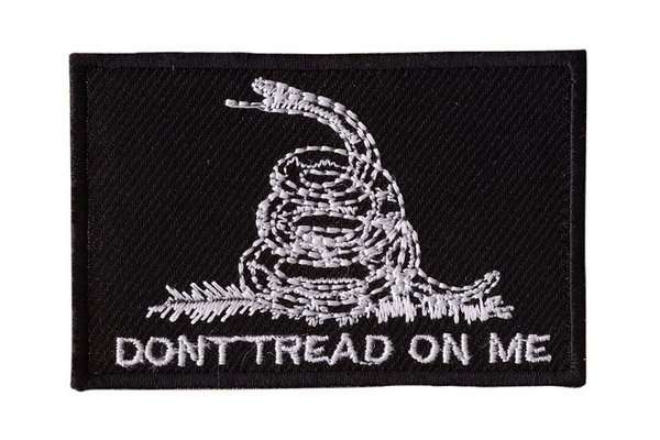 Front view of a black embroidered biker patch featuring white stitching and a border