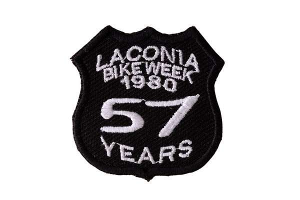 Front view of a black embroidered biker patch with white stitching