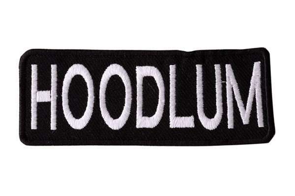 Front view of a black embroidered biker patch with white stitching