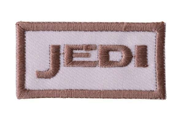 Close-up of a white and brown embroidered biker patch with border stitching