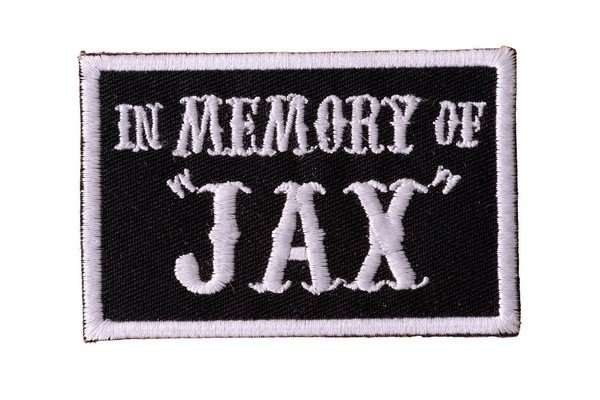 Close-up of a black and white embroidered biker patch with stitching