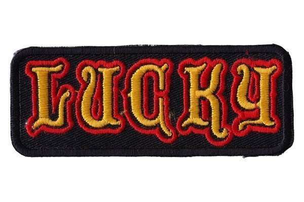 Close-up of a black embroidered biker patch with red and yellow stitching