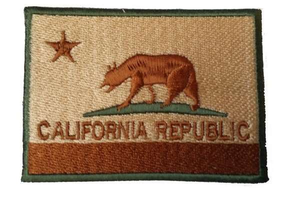 Front close-up of a tan, brown, and green embroidered biker patch with border stitching
