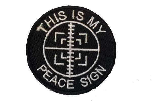 Close-up front view of a black embroidered biker patch with white stitching and borders