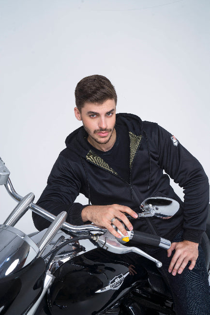 Man sitting on a motorcycle against a white background